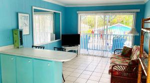 Lantana-Suite-kitchen-living-room-looking-out-to-balcony